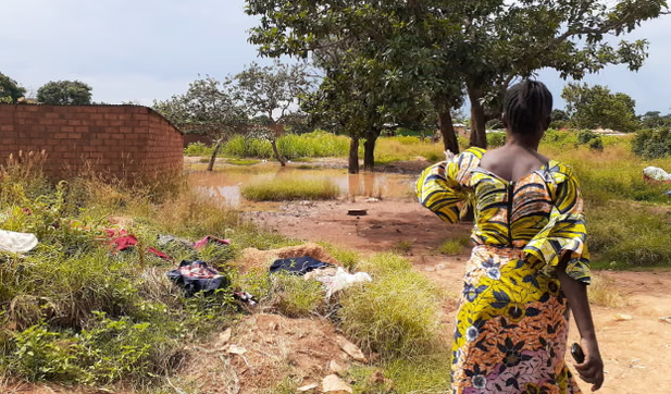 Woman near contaminated water in DRC cobalt mining community